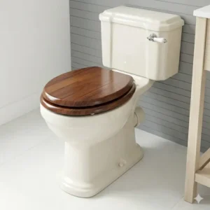 A traditional style floor mounted toilet with an elegant wooden seat and cover.